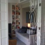 Wnętrze z półkami na książki i sofą, przedstawiające meble na wymiar Augustów.